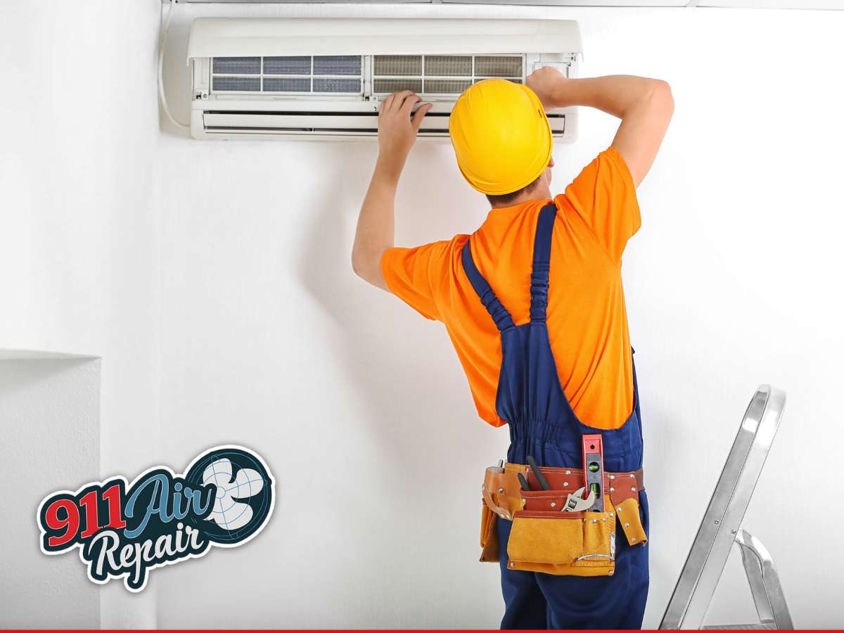 Technician performing AC installation on a wall-mounted unit