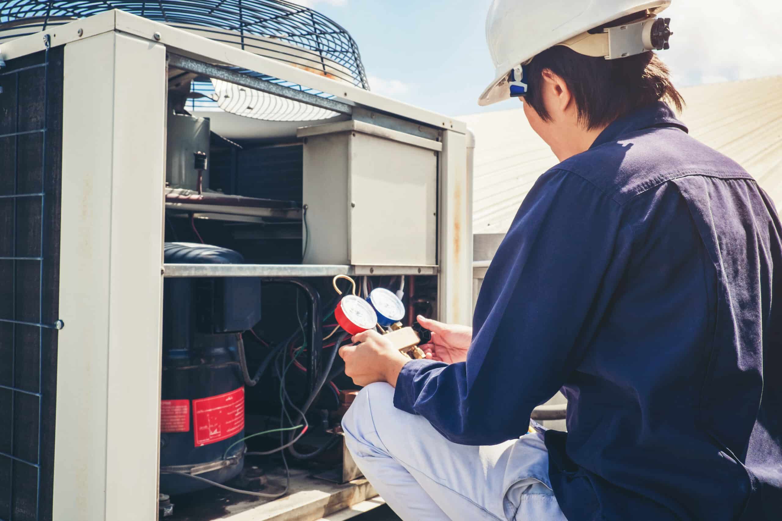Technician checking an air conditioning system for indoor air quality and AC installation